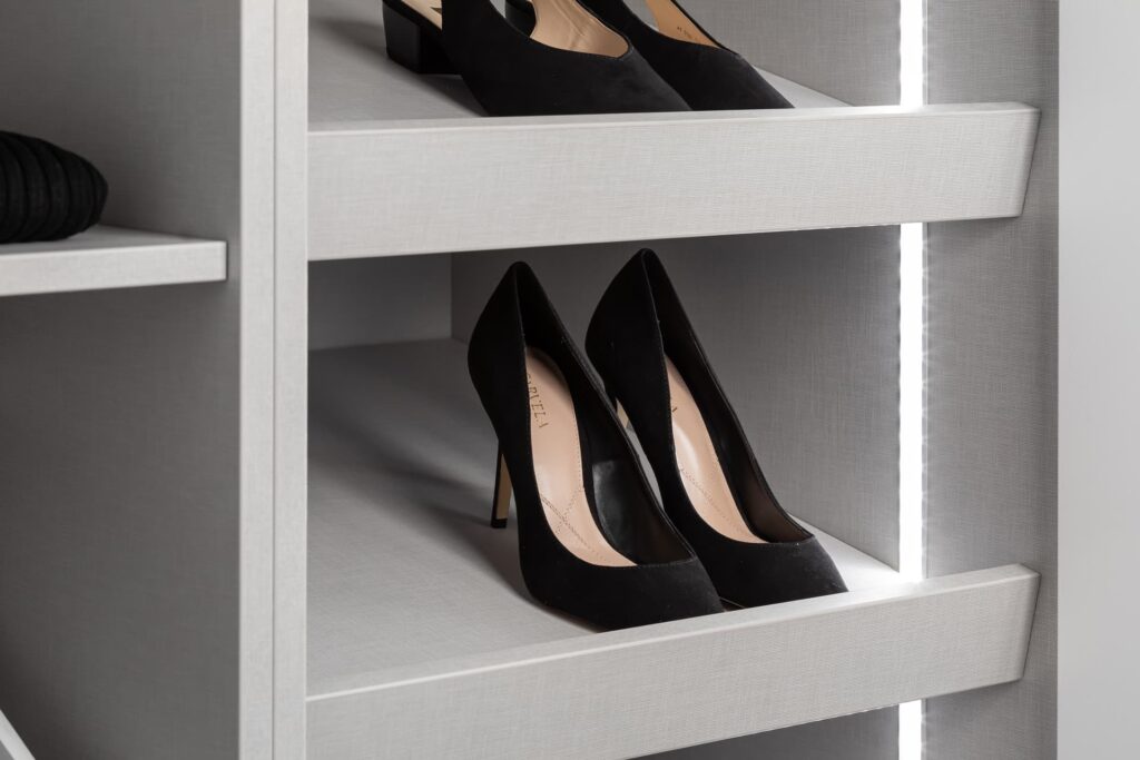 A classic white shelf with a pair of black high heels