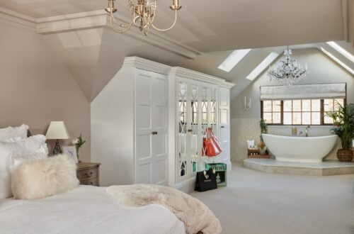 The Heritage Wardrobe Company Luxury Fitted Wardrobes Made-to-measure wardrobe with a bathtub and a large bed