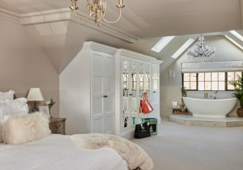 The Heritage Wardrobe Company Luxury Fitted Wardrobes Made-to-measure wardrobe with a bathtub and a large bed