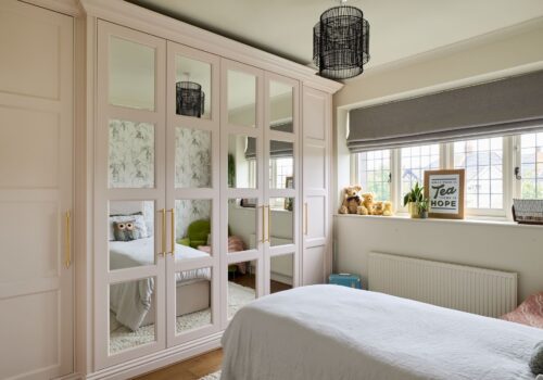 Sarah Llyod 37 pink fitted wardrobes with panelled mirrored doors.