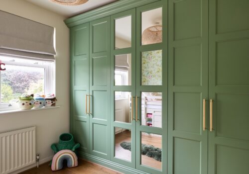 Edwardian style fitted wardrobes in green with mirrored doors