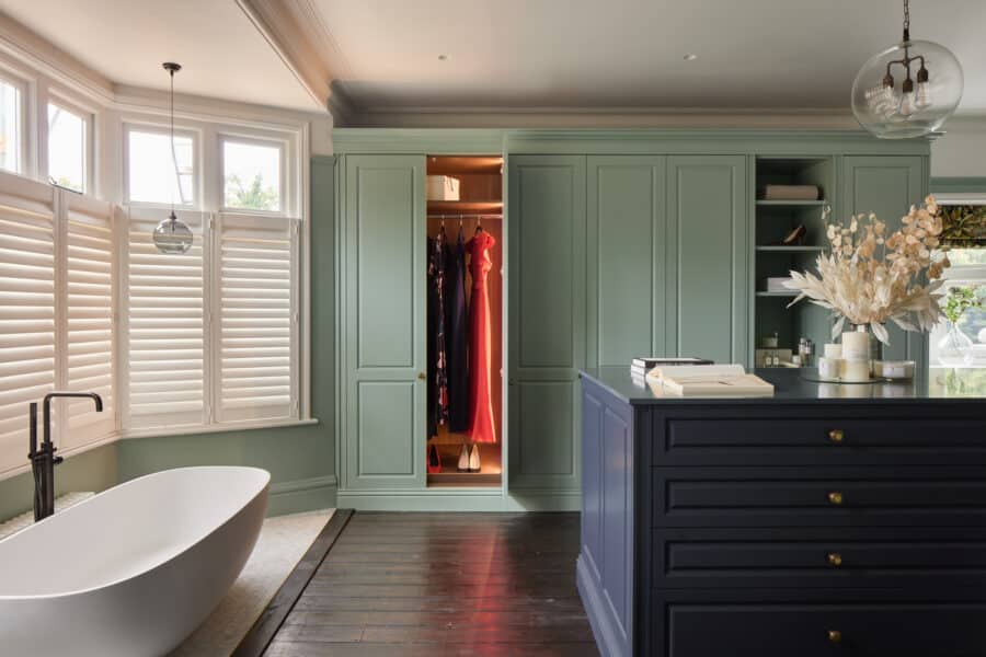 Jubilee fitted wardrobes with doors open and internal lighting. with island in blue