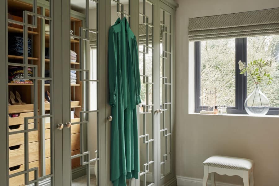 White mirrored Wentworth fitted wardrobe with green dress hanging