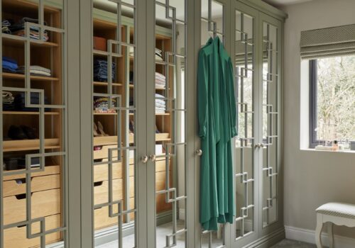 Woking - Wilson 26 White mirrored Wentworth fitted wardrobe with open shelving opposite that is reflected in mirrored doors