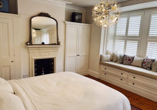 cb 1 White Tilford fitted wardrobes built around chimney and fireplace
