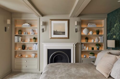 Heritage Wardrobes - Wall Hall4031-2160x1440 Matching Victorian style built-in shelving either side of fireplace in a bedroom - with dimmed light on