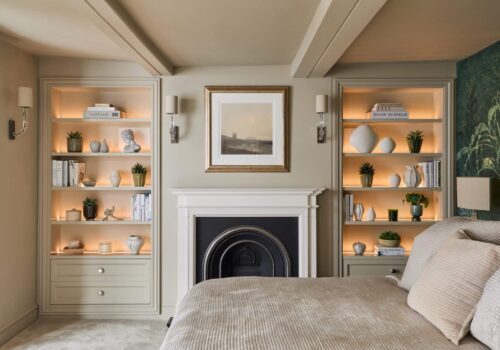 Heritage Wardrobes - Wall Hall4032-2160x1440 Matching Victorian style built-in shelving either side of fireplace in a bedroom - with light on