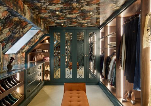 Heritage Wardrobe - Kings Rd 13 bespoke loft conversion into luxury dressing room. Including vibrant floral wallpaper, dark green wardrobes with mirrored doors and soft LED lighting