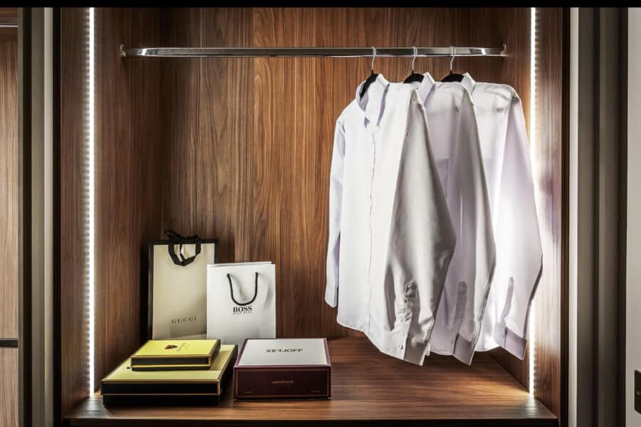 Luxury fitted wardrobe with LED lighting, designer shirts and designer branded bags