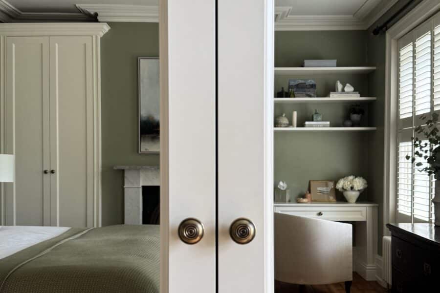 Classic style fitted wardrobe reflected in mirrored wardrobe door